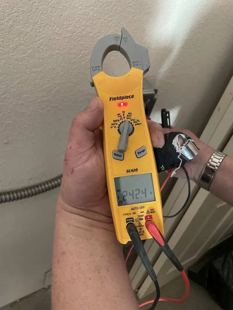 Voltage testing with clamp meter during Electrical Installation Services in Fayette